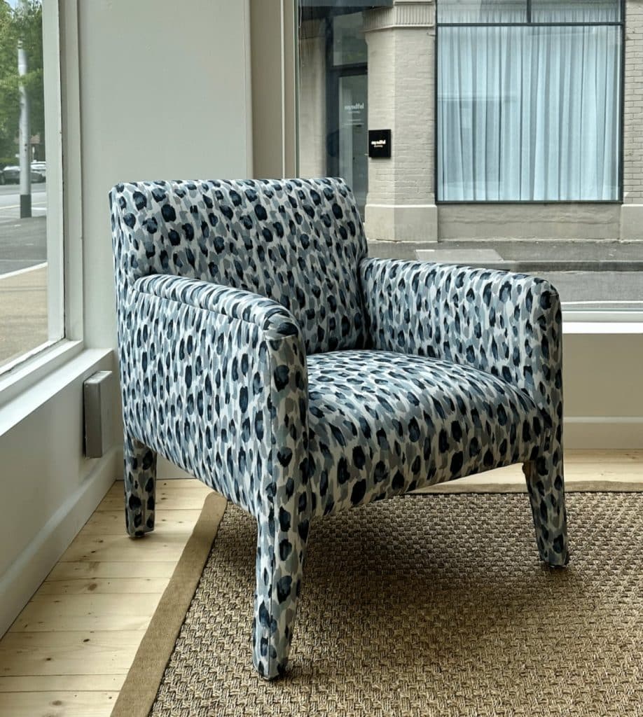Bold patterned armchair in a modern interior with natural light and wooden flooring. Shop stylish seating today.