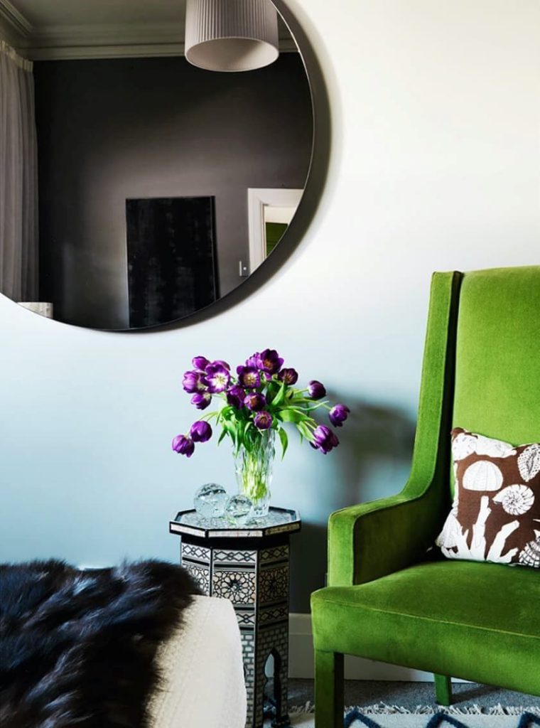 Round mirror adding depth to compact interior spaces