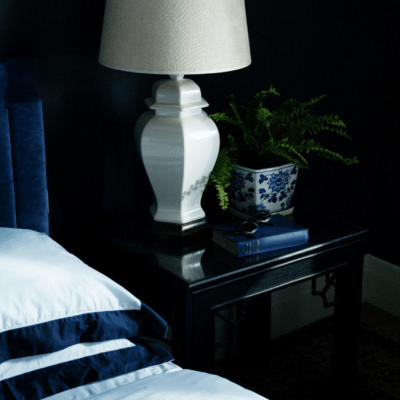 Bedroom decor styling. Lamp and Vase on bedside table