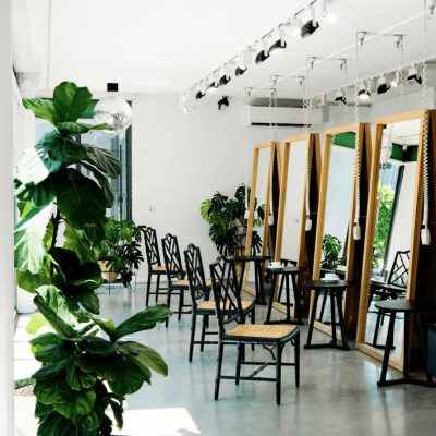 natural light shining through the studio. mirrors and chairs.